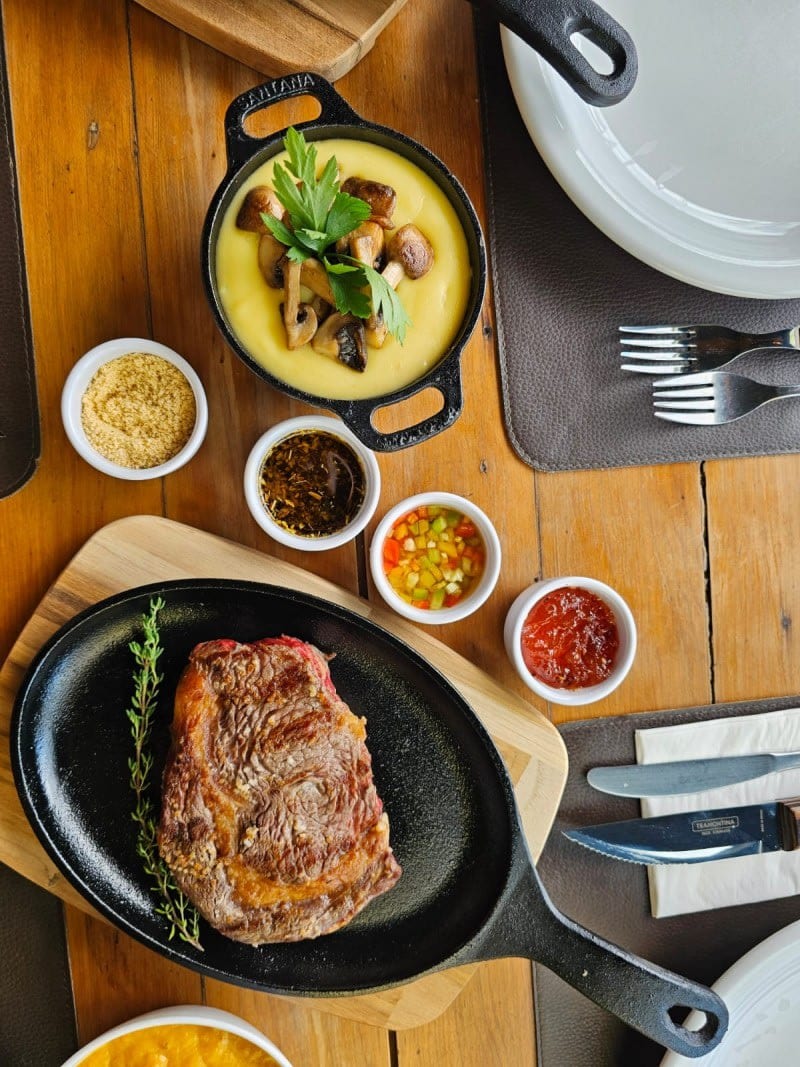 Prato de carne grelhada com acompanhamentos no Sello Restaurante