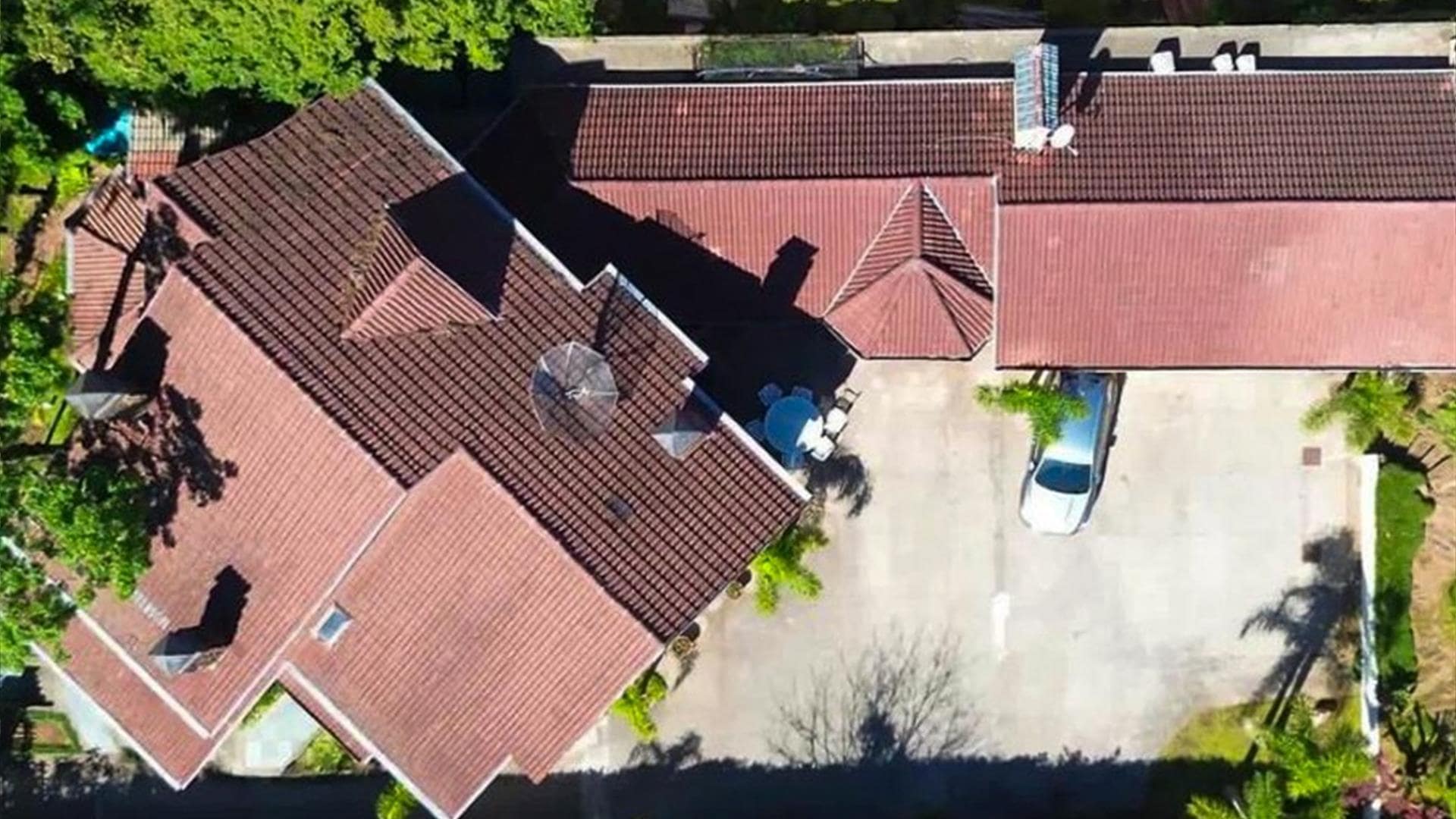 Vista aérea do casarão e do estacionamento da Vivares Pousada Boutique Gramado, em Gramado