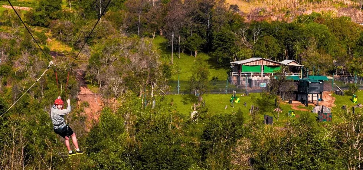 Tirolesa sobre a mata com a sede do Parque Gasper ao fundo, em Bento Gonçalves